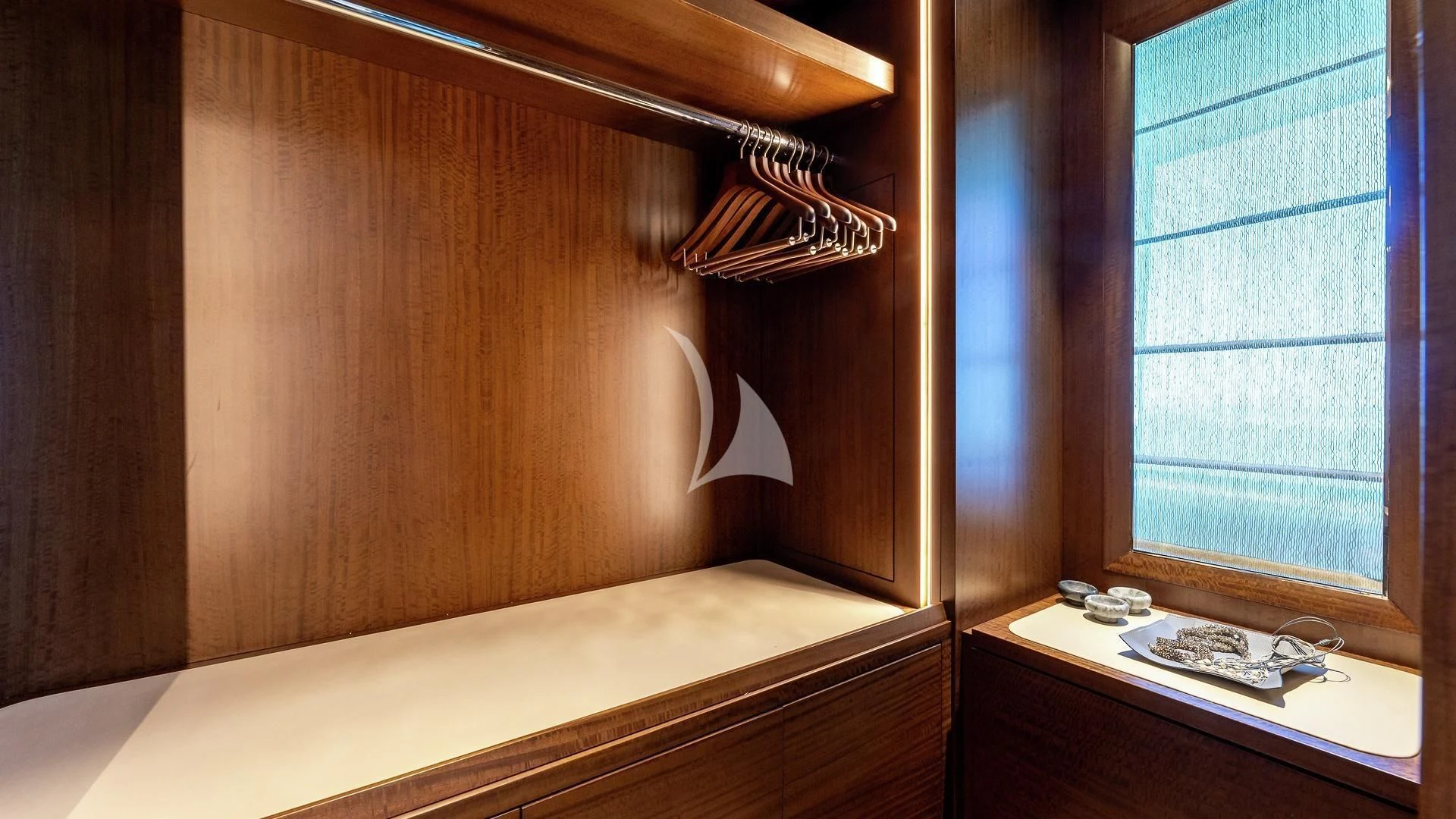 a wooden cabinet with a sink and a window aboard ENTERPRISE Yacht for Charter