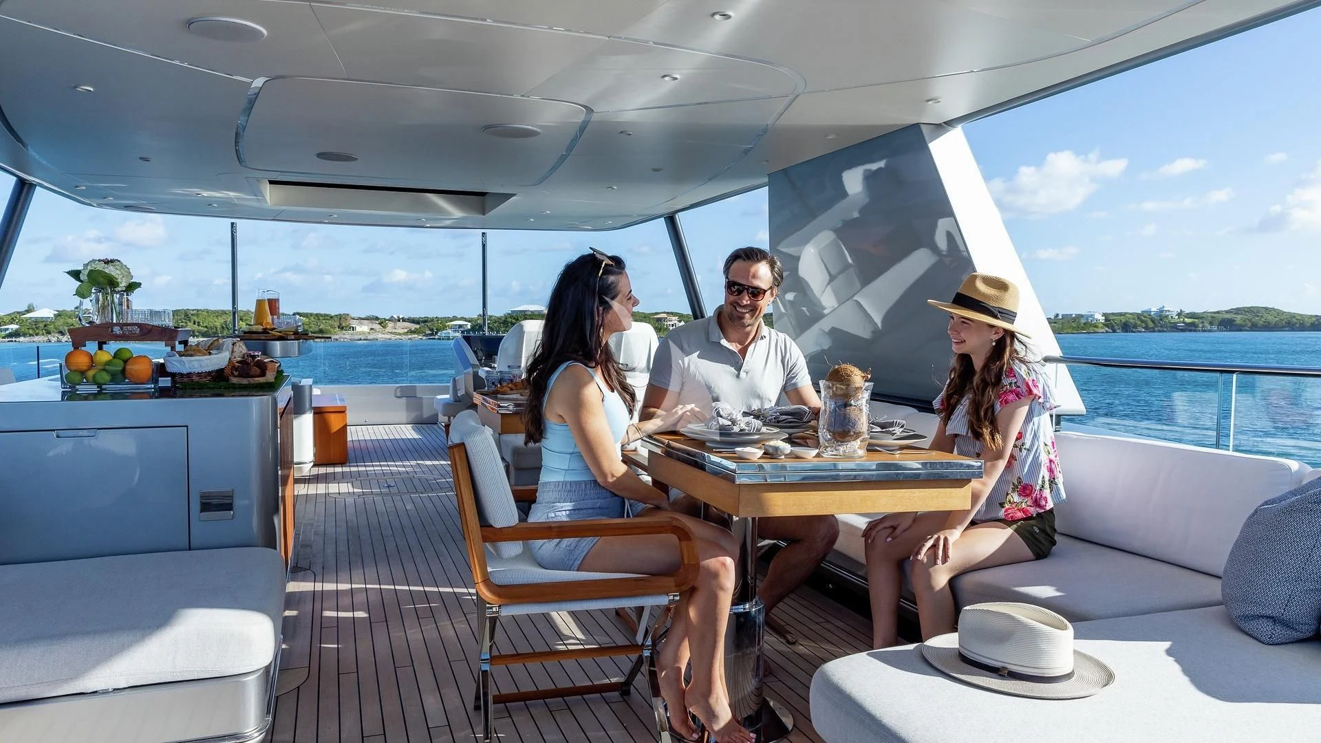 a group of people sitting at a table outside aboard ENTERPRISE Yacht for Charter