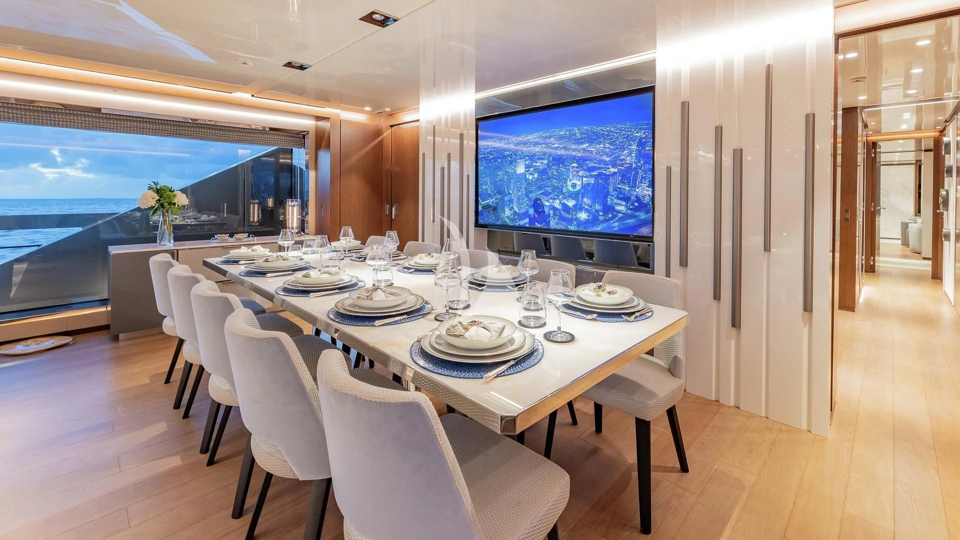 a large dining table with white plates aboard ENTERPRISE Yacht for Charter