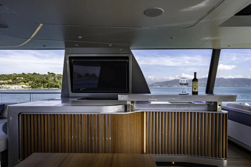 a room with a tv and a window aboard ENTERPRISE Yacht for Charter