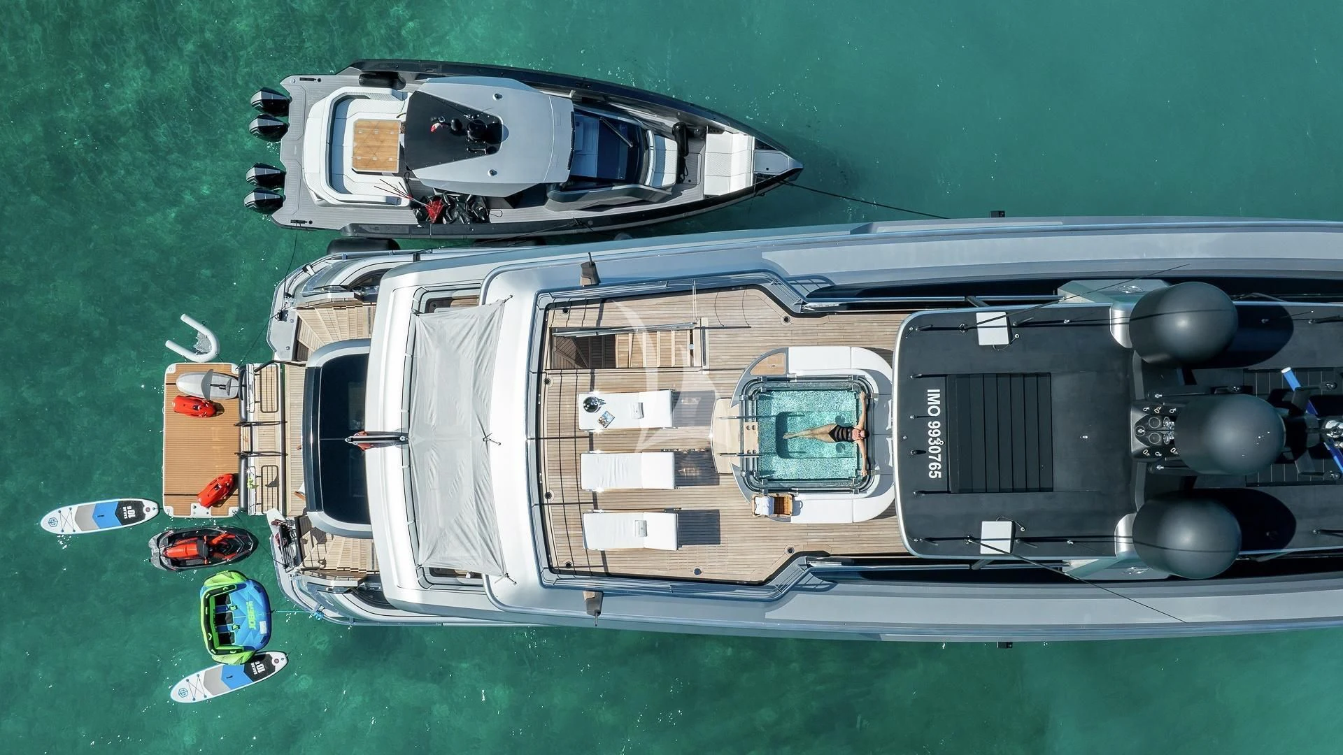 a large grey vehicle with a large black top and a white trailer aboard ENTERPRISE Yacht for Charter