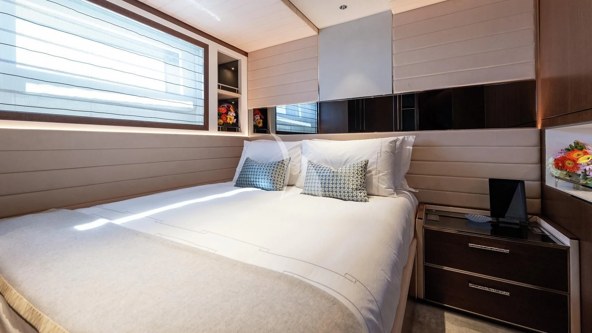 a bedroom with a bed and a television aboard ENTERPRISE Yacht for Charter