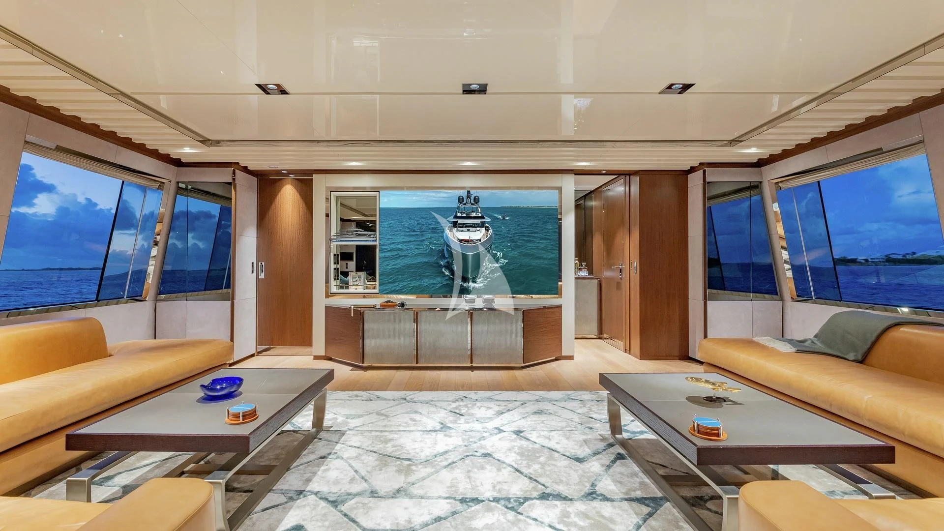 a living room with a large screen aboard ENTERPRISE Yacht for Charter