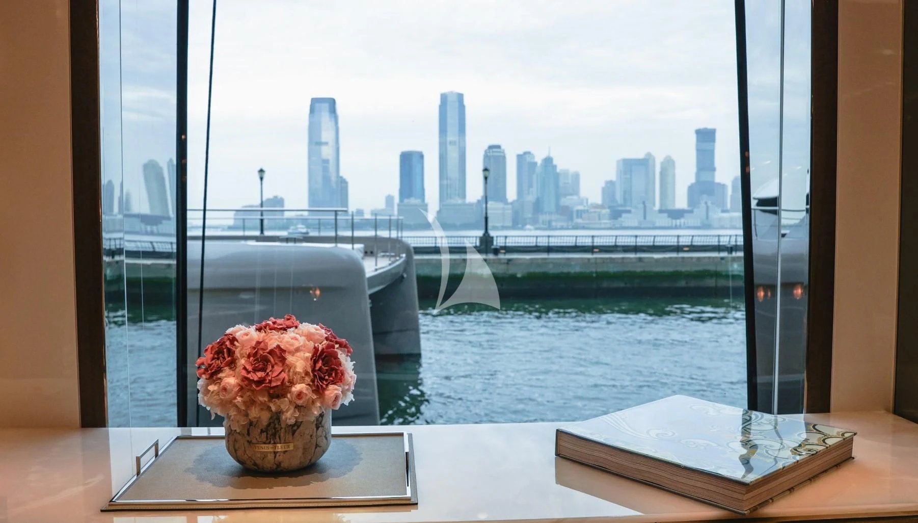 a window with a city skyline in the background aboard ENTERPRISE Yacht for Charter