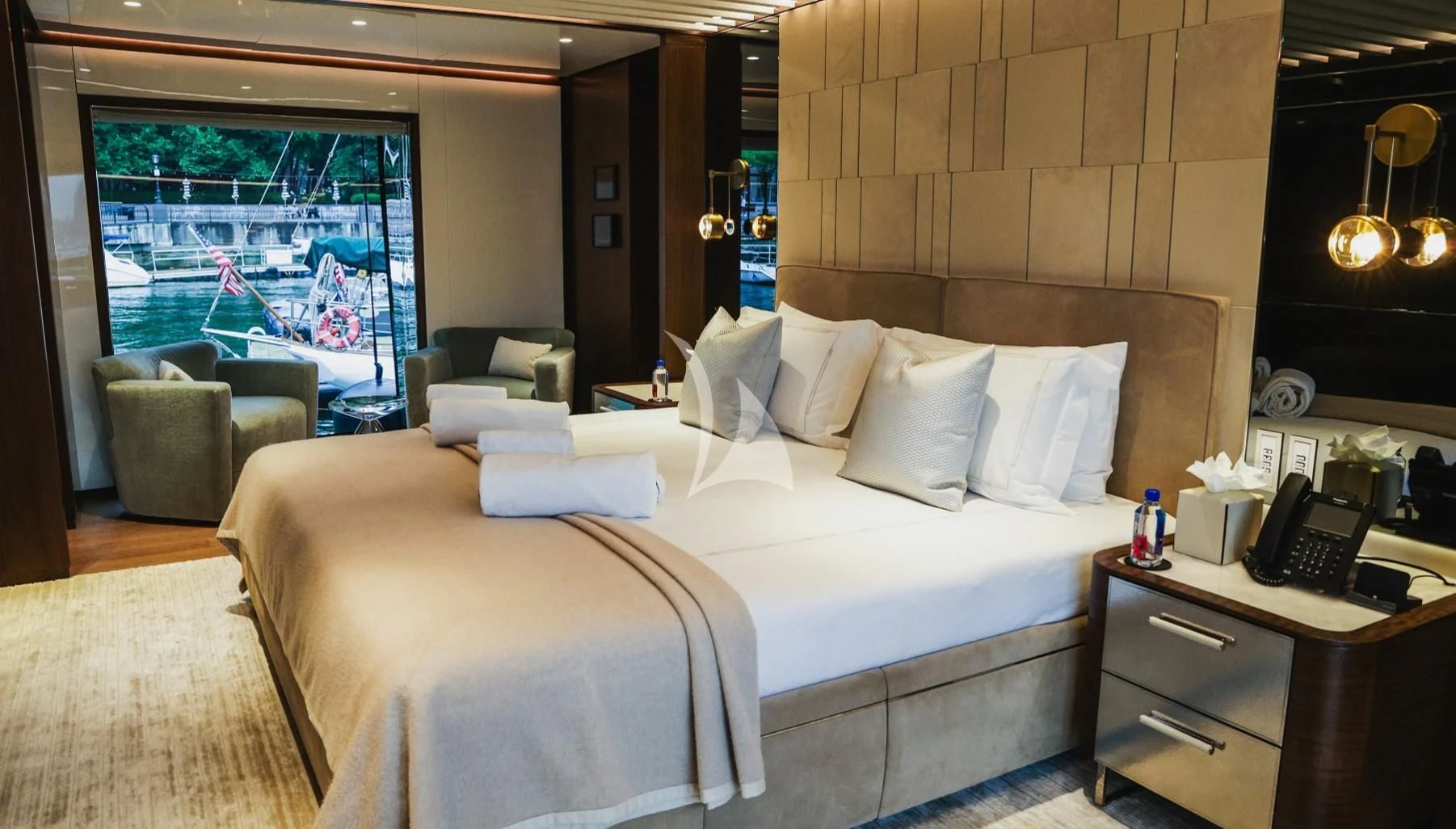 a hotel room with a bed and a desk aboard ENTERPRISE Yacht for Charter