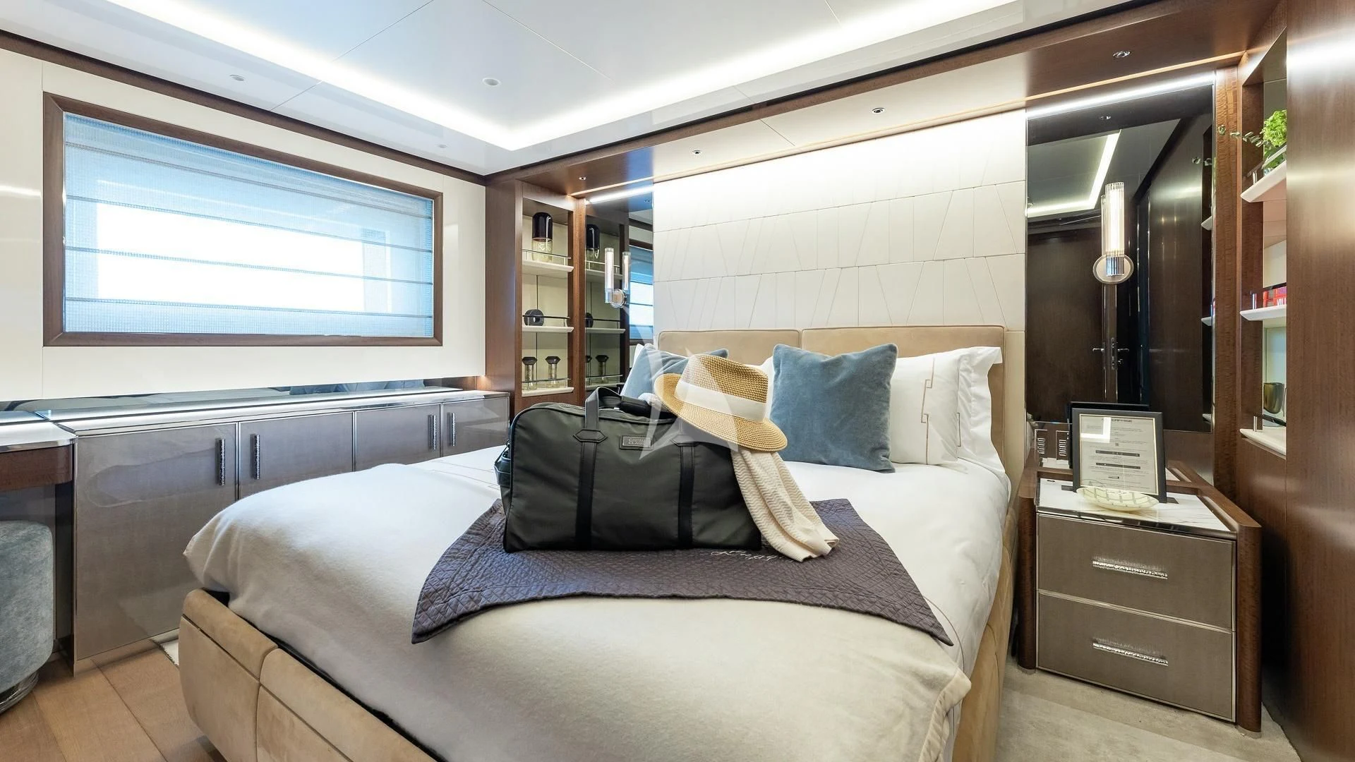 a bedroom with a bed and a desk aboard ENTERPRISE Yacht for Charter