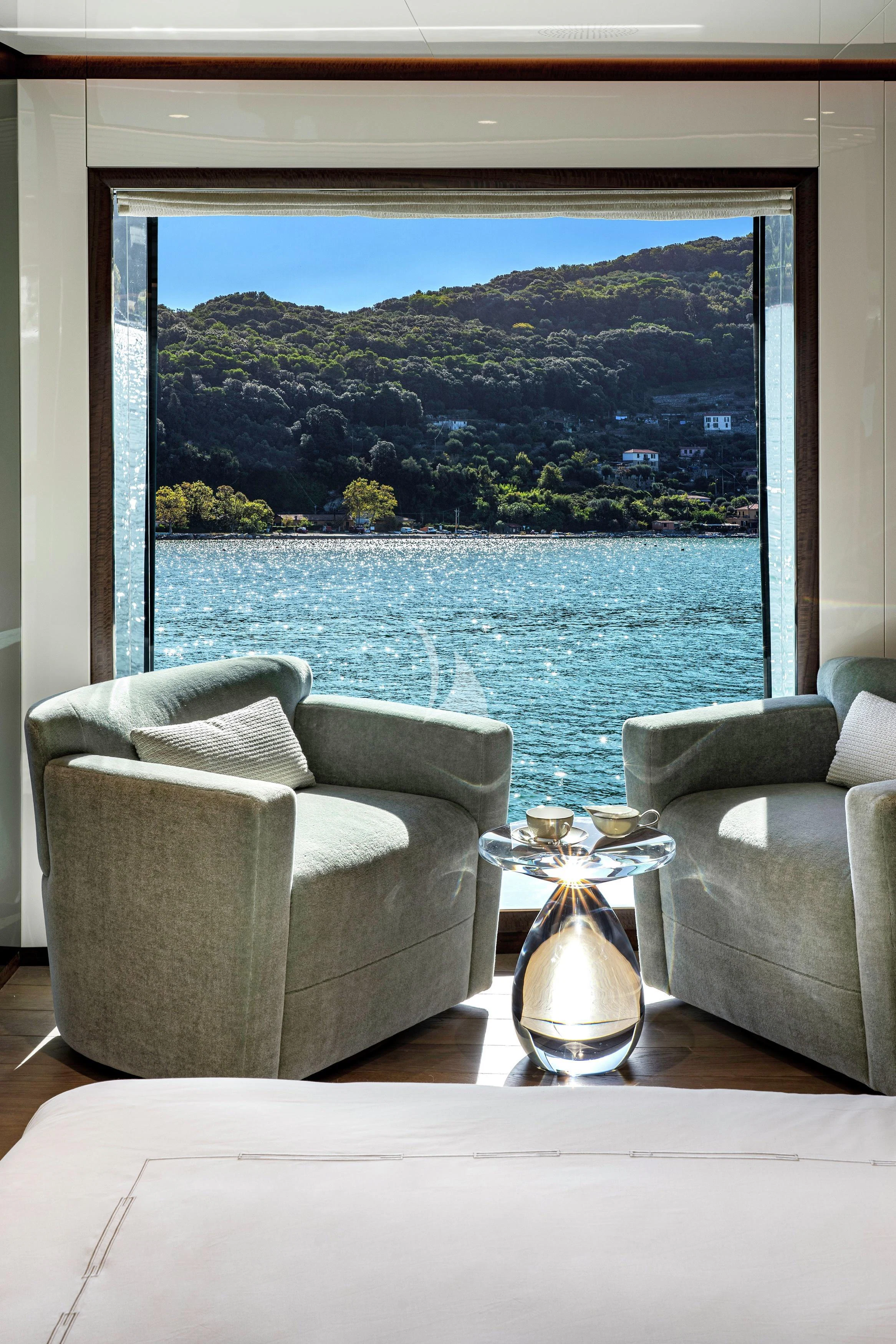 a room with a view of the ocean and mountains aboard ENTERPRISE Yacht for Charter