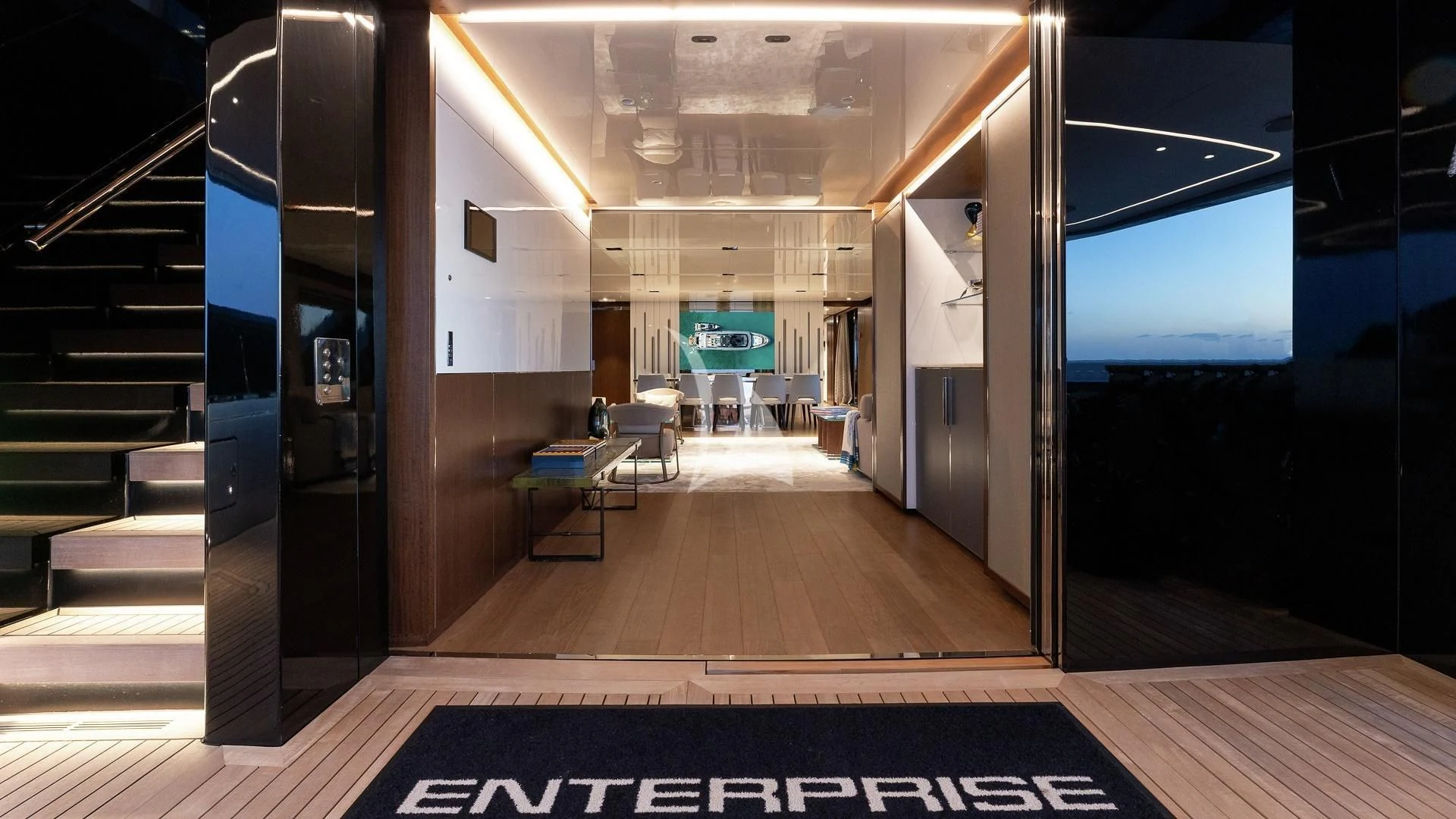 a room with a wood floor and a large window aboard ENTERPRISE Yacht for Charter