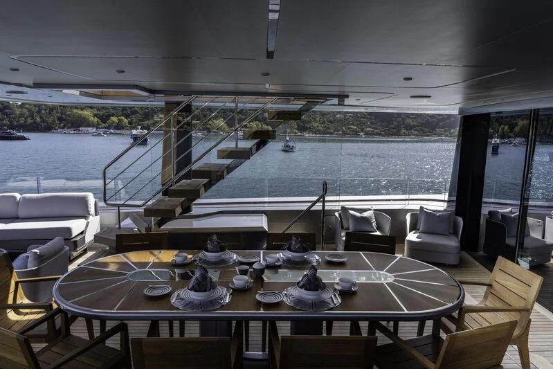 a table with chairs and a view of a body of water aboard ENTERPRISE Yacht for Charter