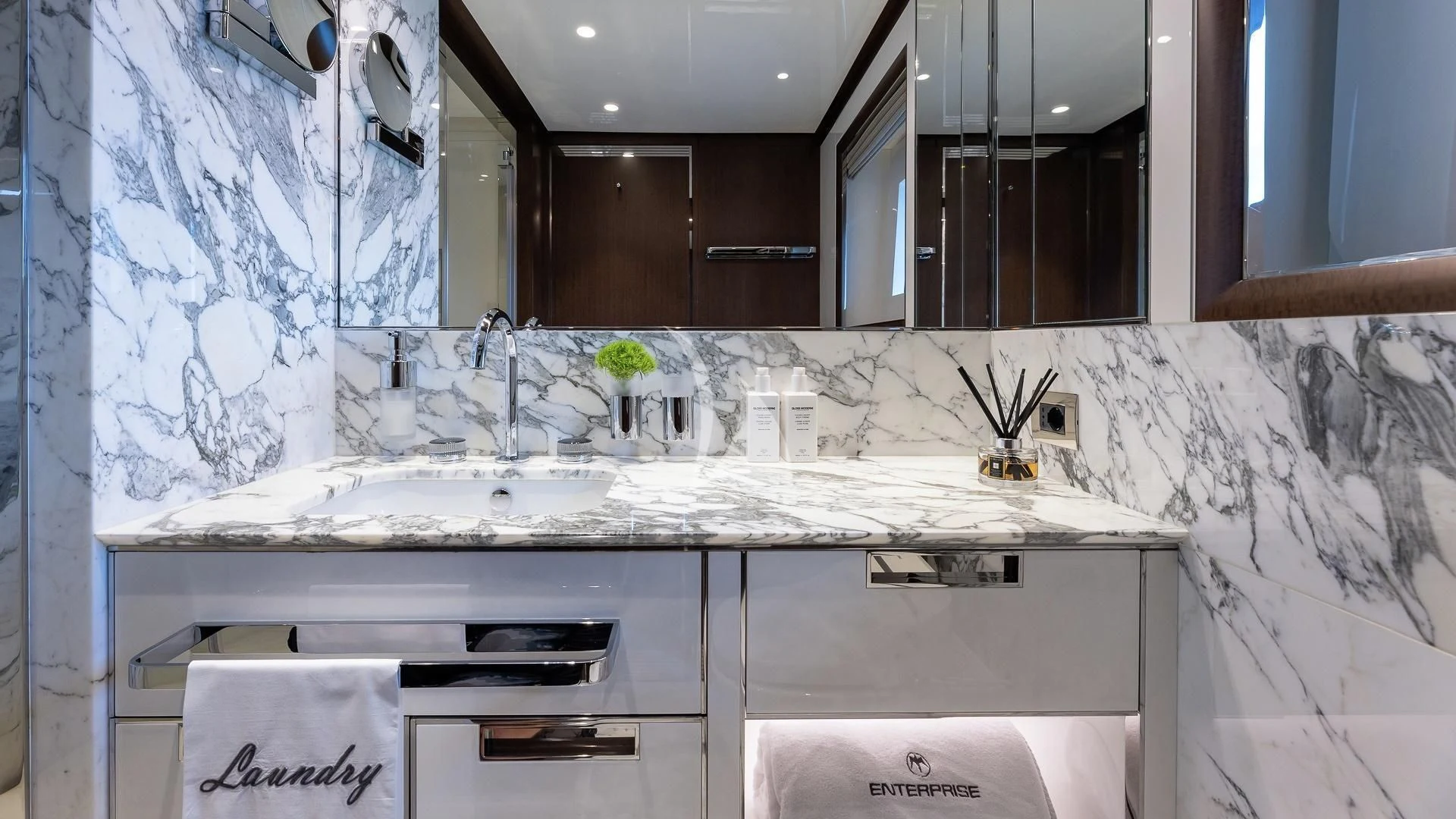 a kitchen with white tiles aboard ENTERPRISE Yacht for Charter