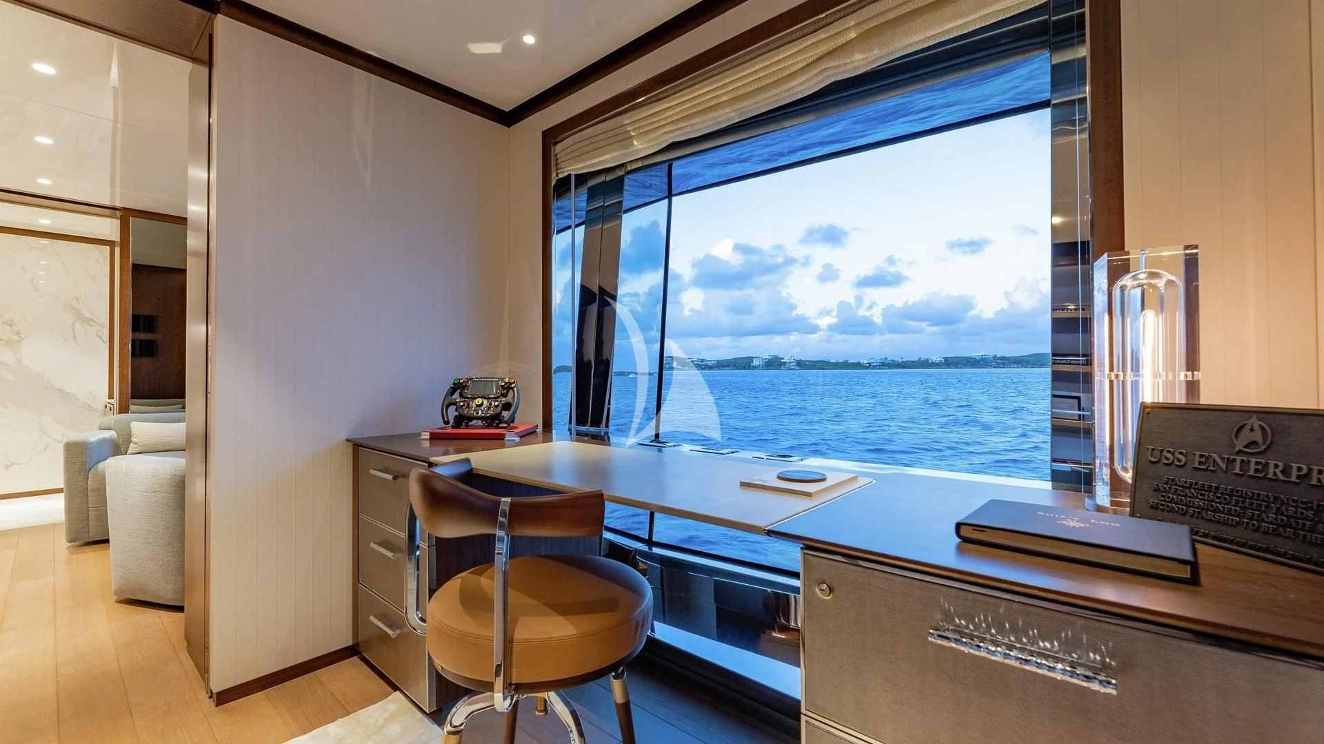 a room with a desk and a window aboard ENTERPRISE Yacht for Charter