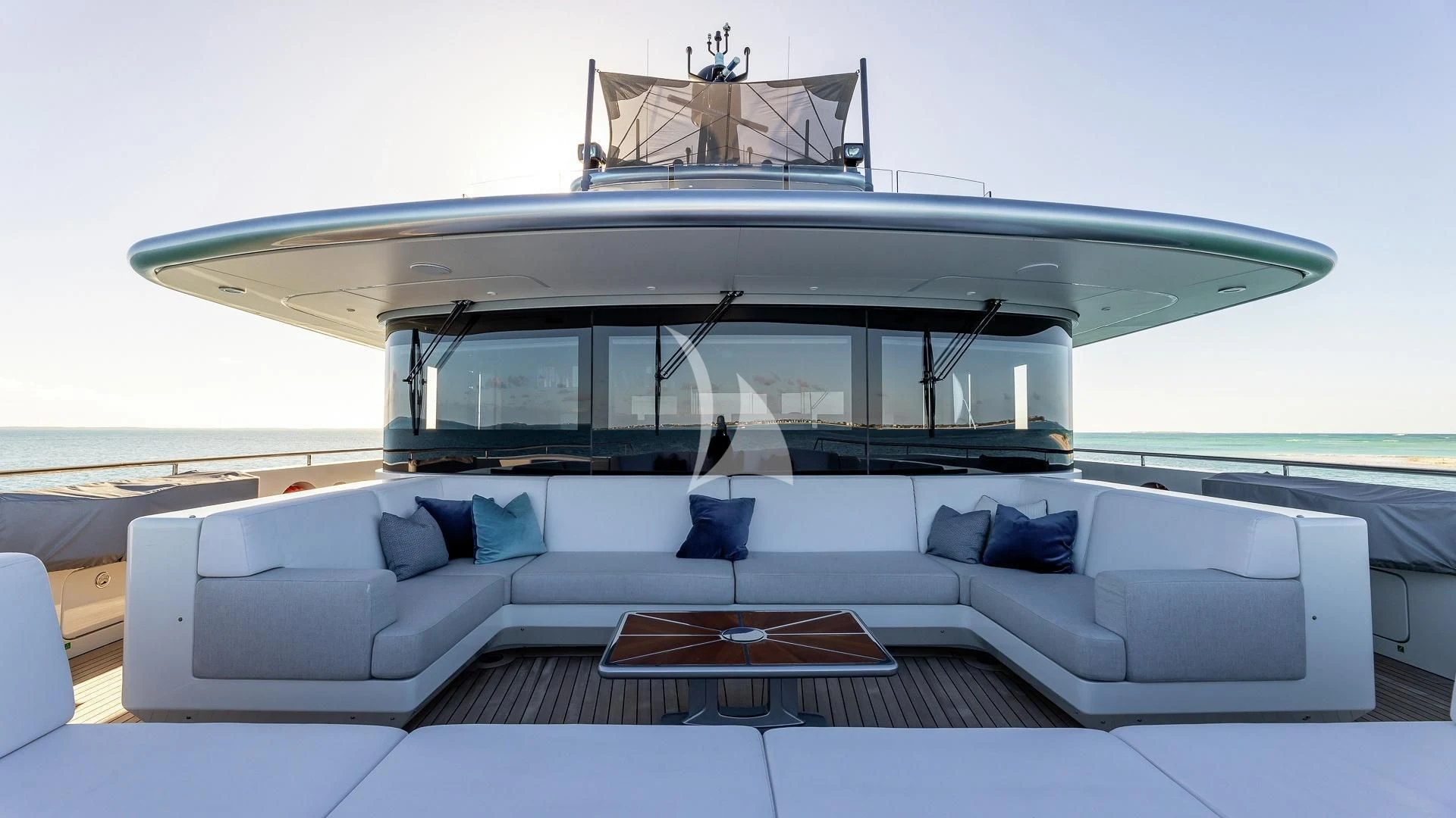 a white couch with a table on it aboard ENTERPRISE Yacht for Charter