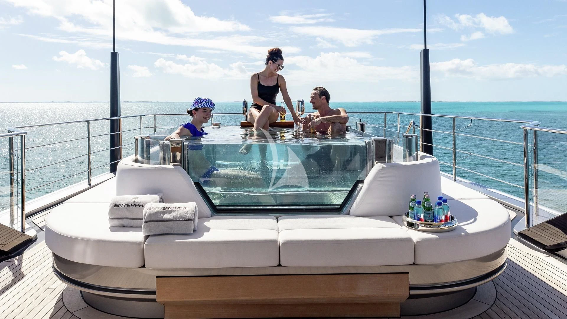 a group of people sitting on a boat in the water aboard ENTERPRISE Yacht for Charter