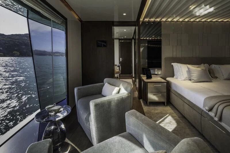 a room with a bed and a window aboard ENTERPRISE Yacht for Charter