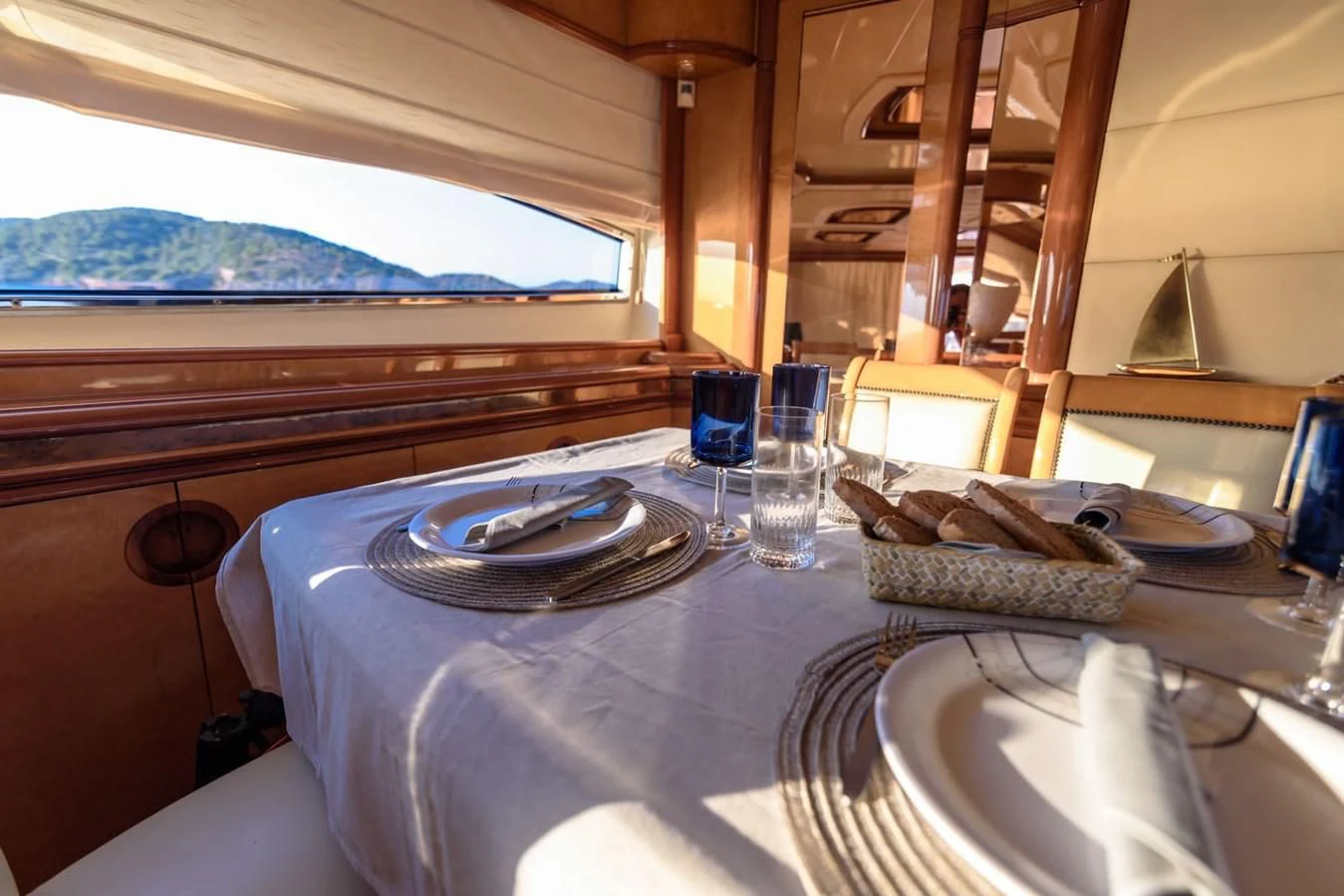 a table with plates and glasses aboard NEPHENTA PRIMERO Yacht for Sale