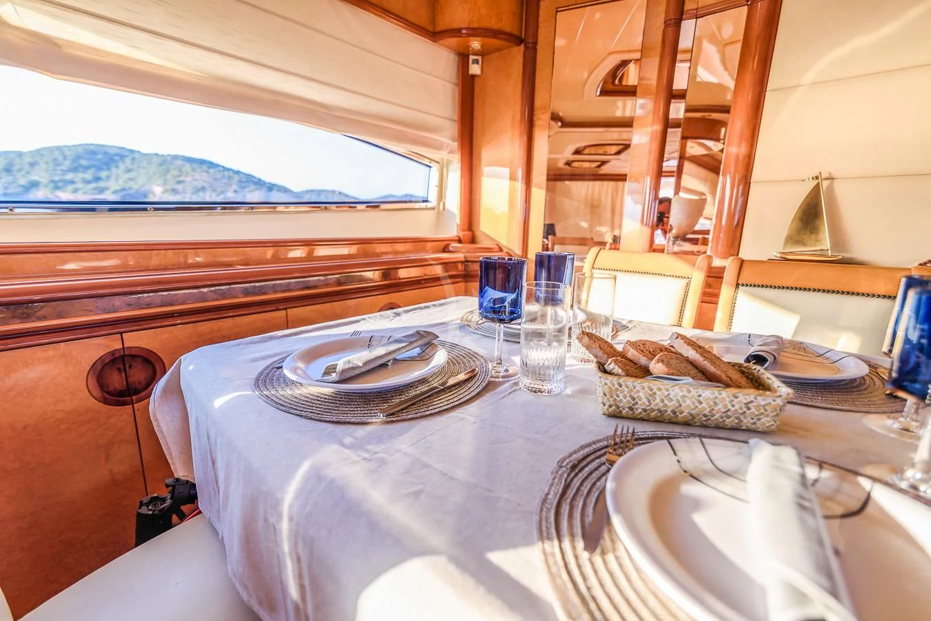 a table with plates and glasses on it aboard NEPHENTA PRIMERO Yacht for Sale