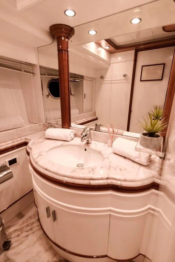 a bathroom with a large mirror aboard NEPHENTA PRIMERO Yacht for Sale