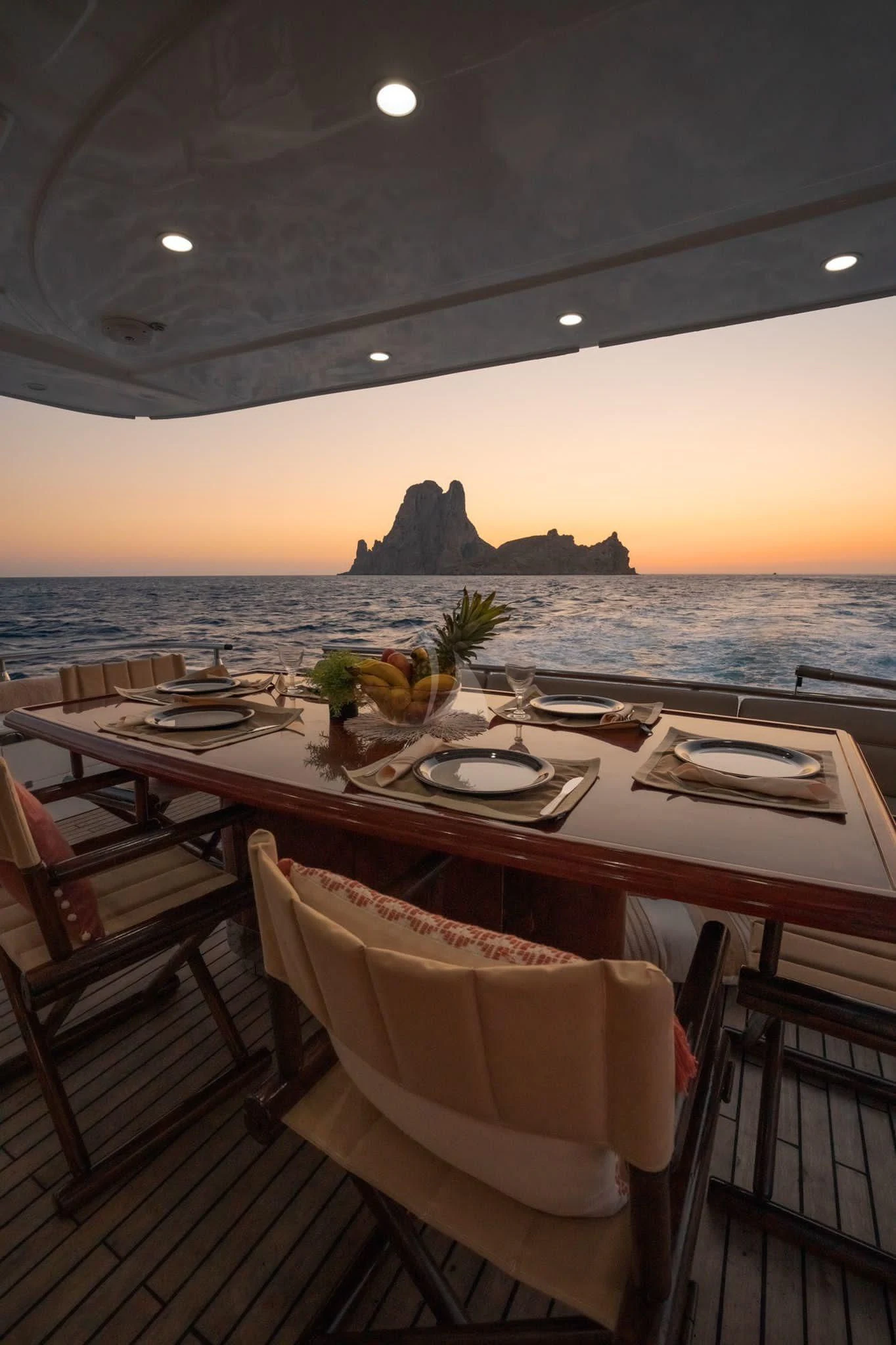 a table with chairs and a view of the ocean aboard NEPHENTA PRIMERO Yacht for Sale