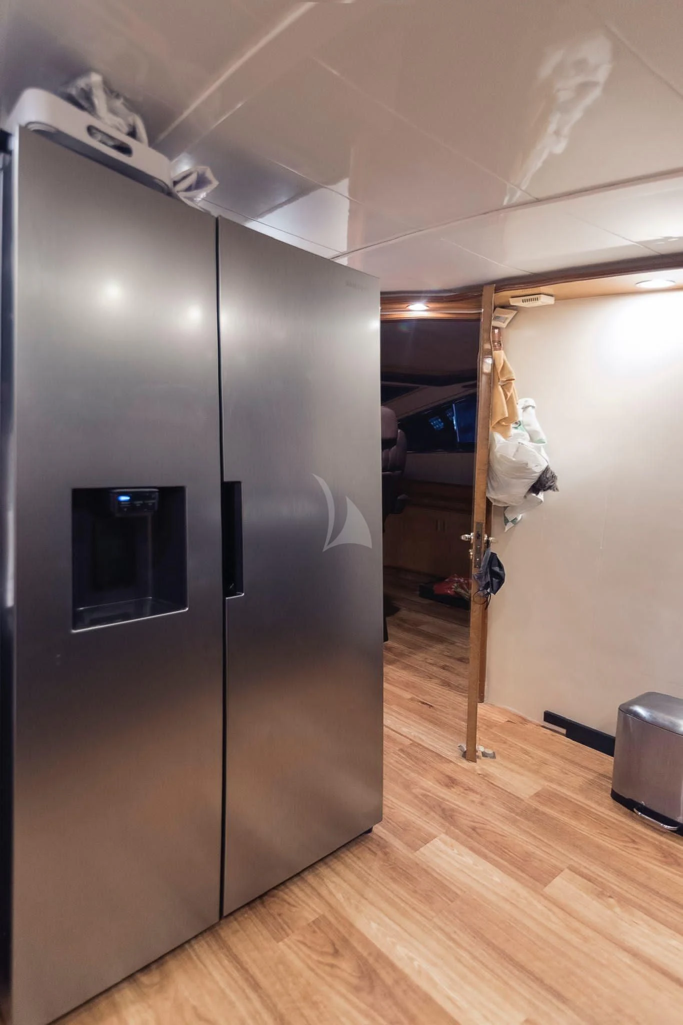 a large silver refrigerator in a room aboard NEPHENTA PRIMERO Yacht for Sale