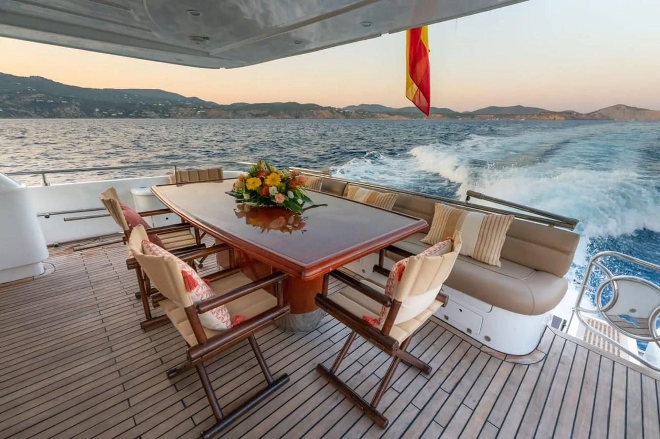 a table on a deck overlooking a body of water aboard NEPHENTA PRIMERO Yacht for Sale