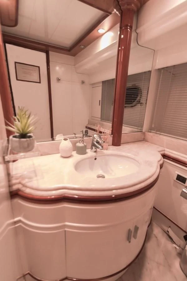 a bathroom with a large mirror aboard NEPHENTA PRIMERO Yacht for Sale