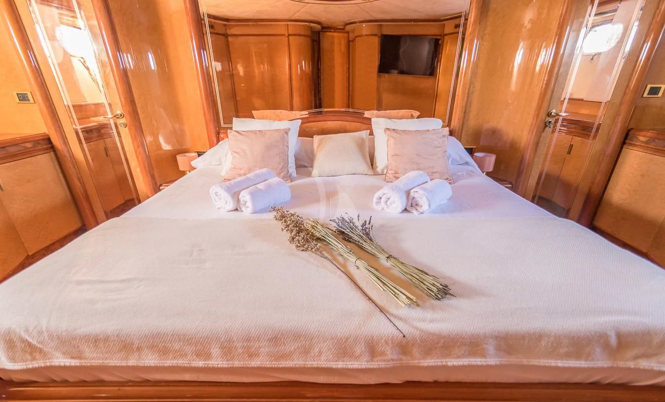 a bed with white sheets and pillows aboard NEPHENTA PRIMERO Yacht for Sale