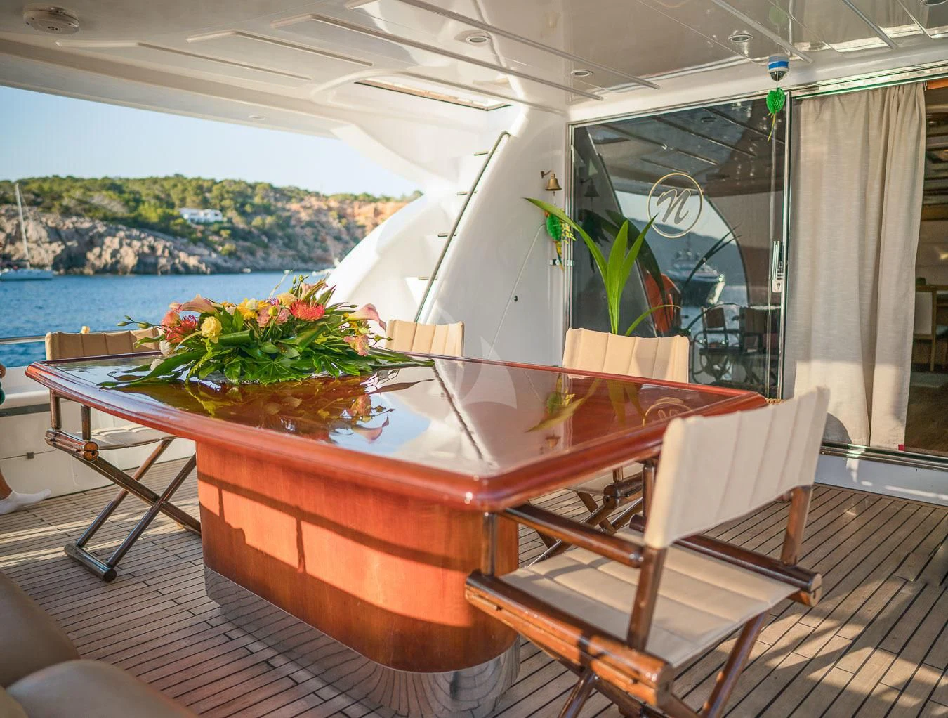 a table with flowers on it aboard NEPHENTA PRIMERO Yacht for Sale