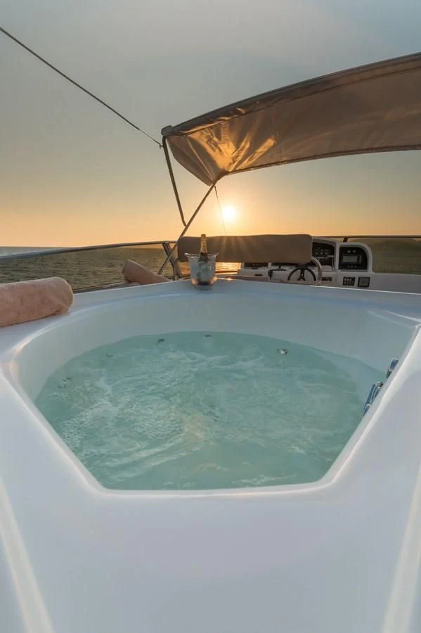 a pool with a boat in the background aboard NEPHENTA PRIMERO Yacht for Sale