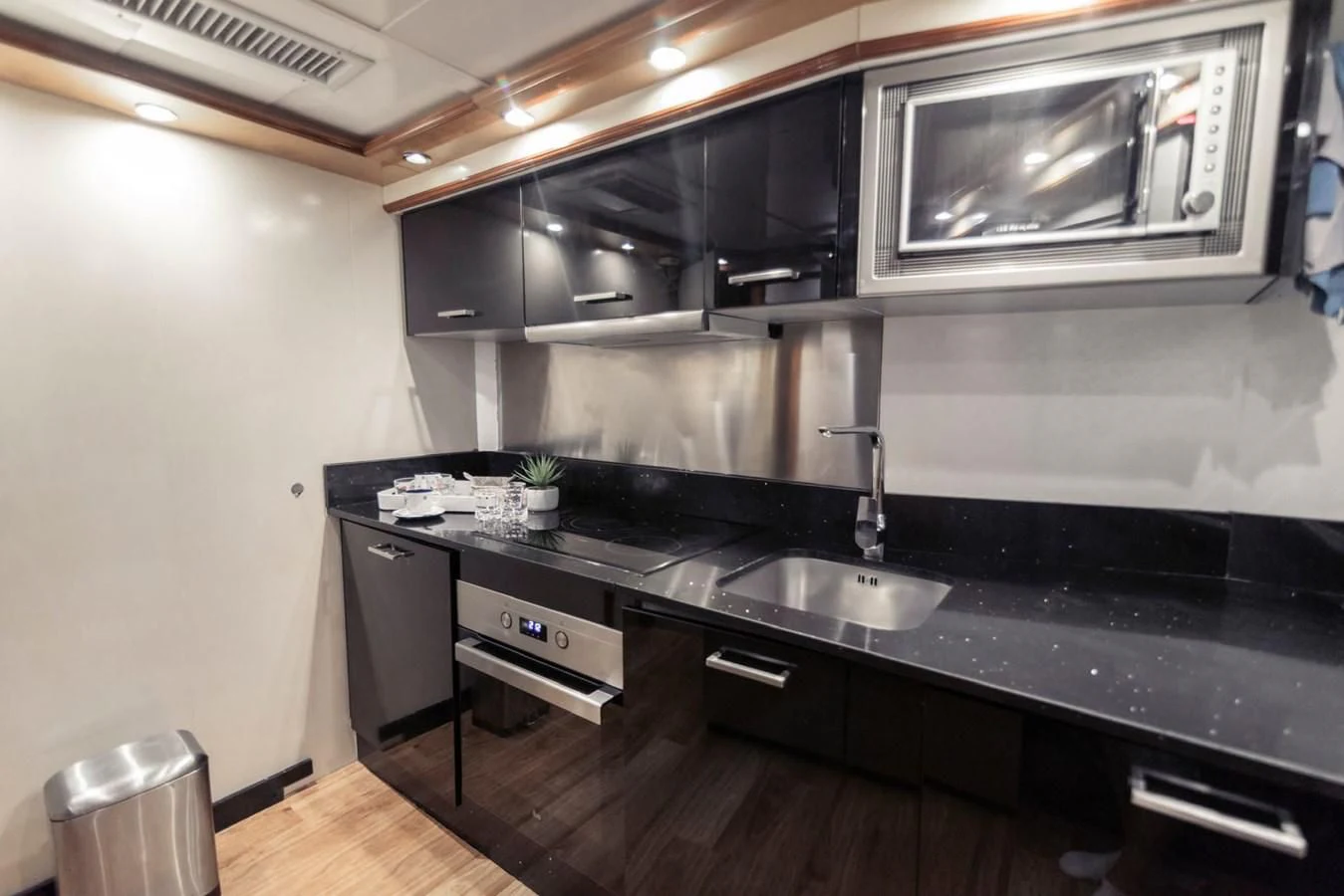 a kitchen with black counter tops aboard NEPHENTA PRIMERO Yacht for Sale