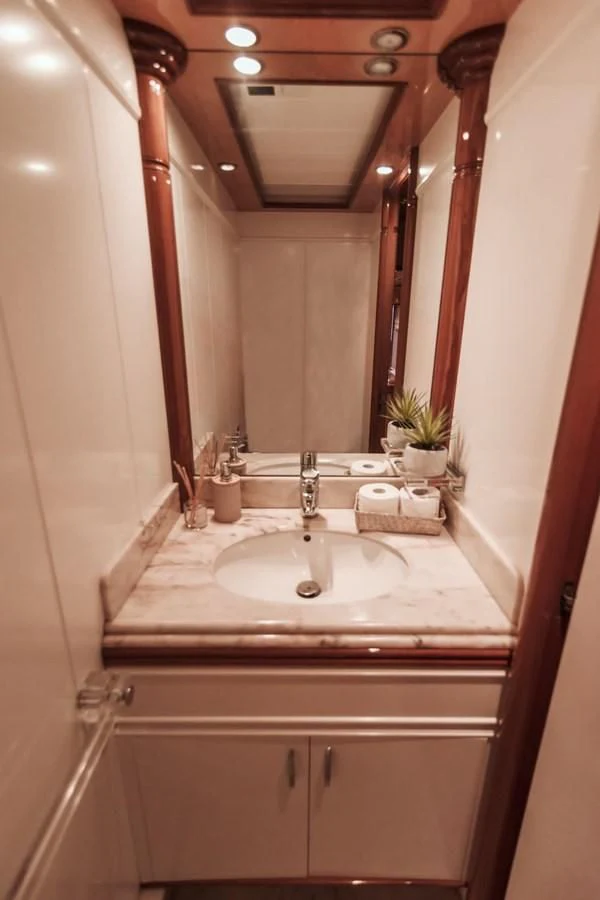 a bathroom with a sink and a mirror aboard NEPHENTA PRIMERO Yacht for Sale