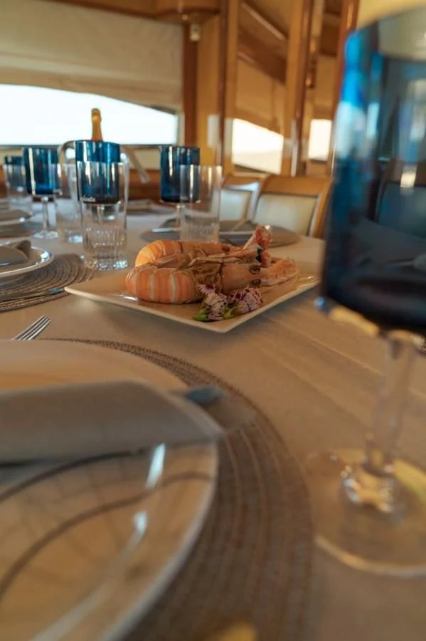 a plate of food on a table aboard NEPHENTA PRIMERO Yacht for Sale