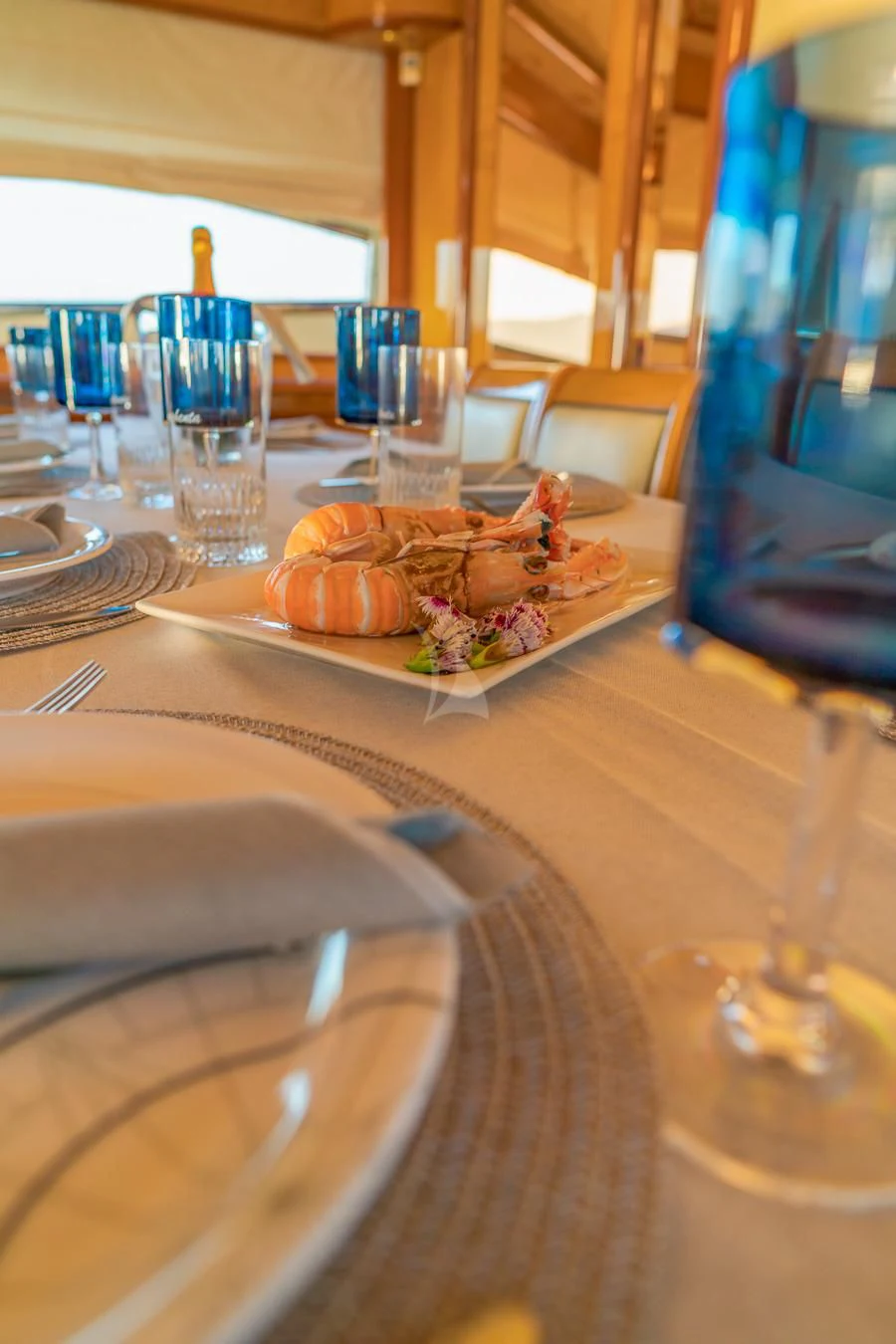 a table with plates and glasses aboard NEPHENTA PRIMERO Yacht for Sale
