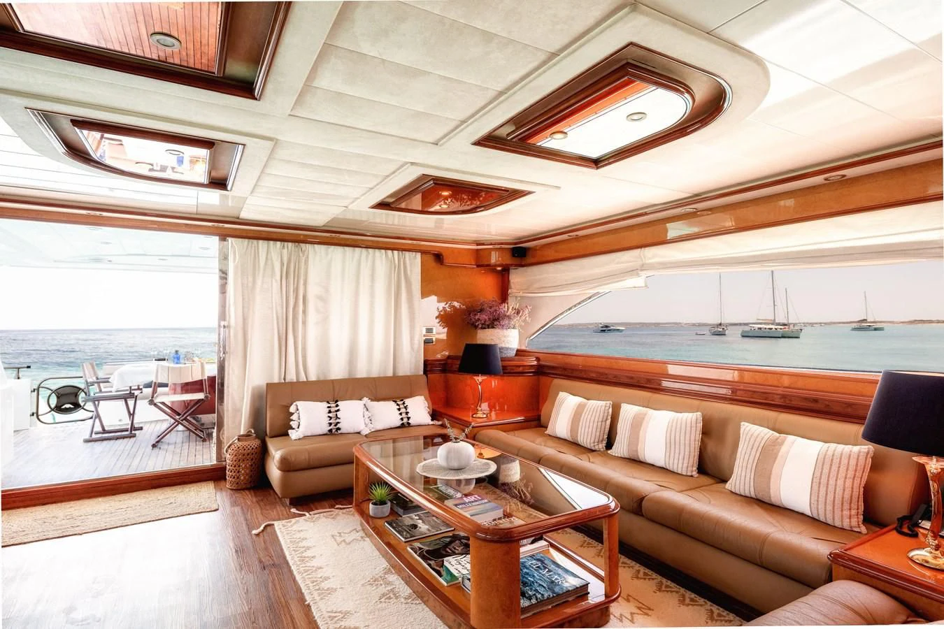 a living room with a couch and a table aboard NEPHENTA PRIMERO Yacht for Sale