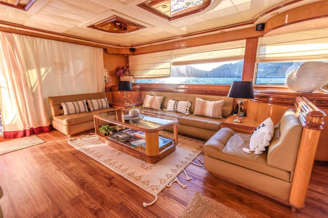 a living room with a large window aboard NEPHENTA PRIMERO Yacht for Sale
