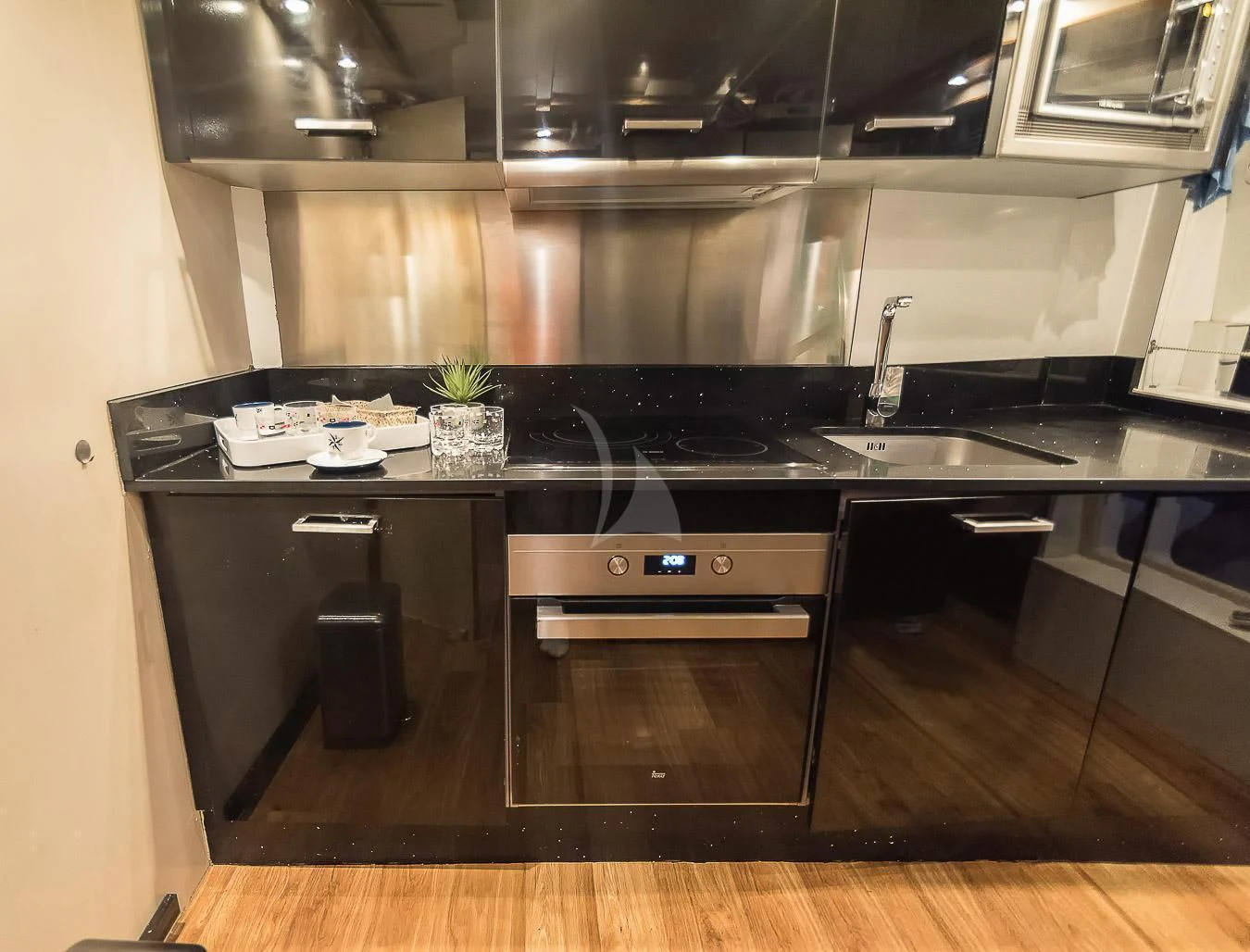 a kitchen with a black counter aboard NEPHENTA PRIMERO Yacht for Sale