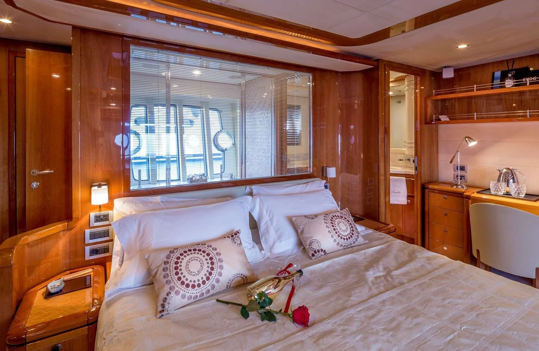 a bed with white sheets and pillows aboard PIOLA Yacht for Sale