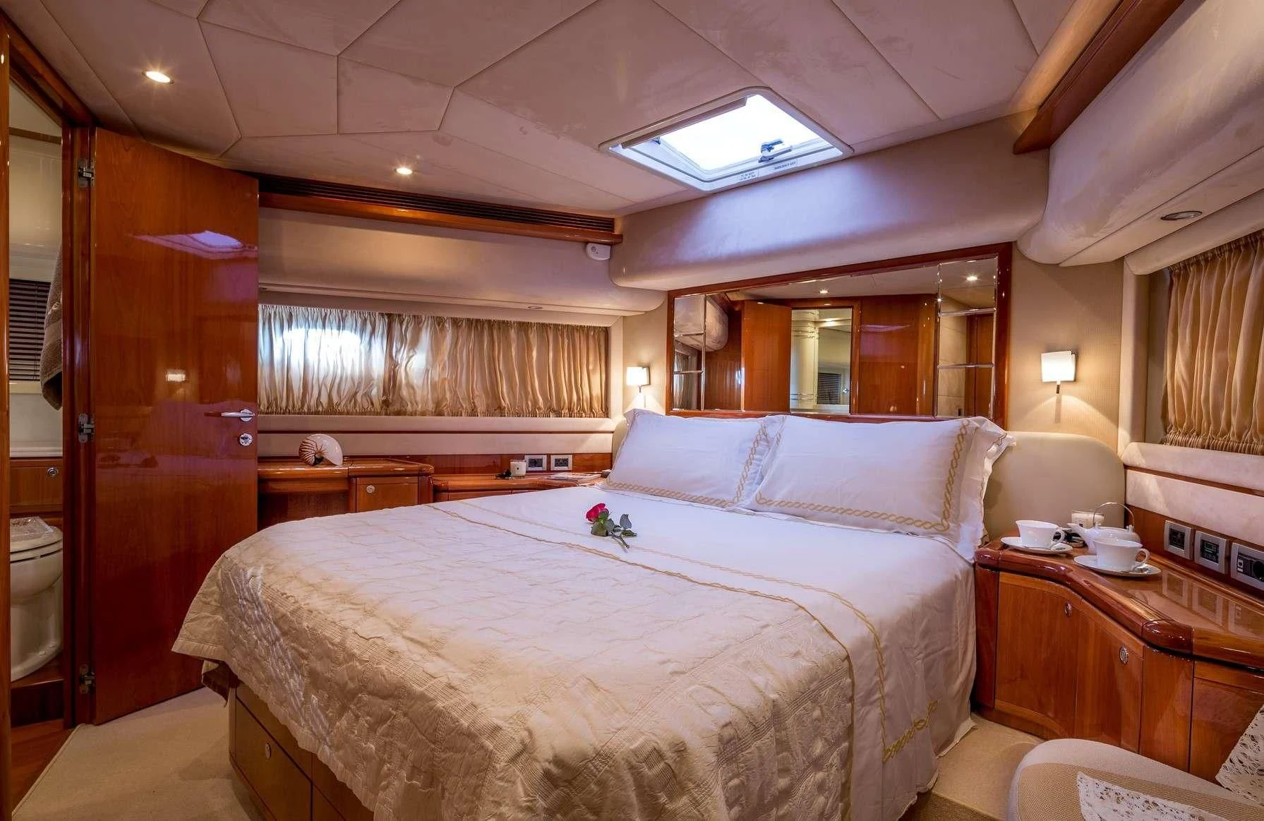 a bedroom with a bed and a desk aboard PIOLA Yacht for Sale