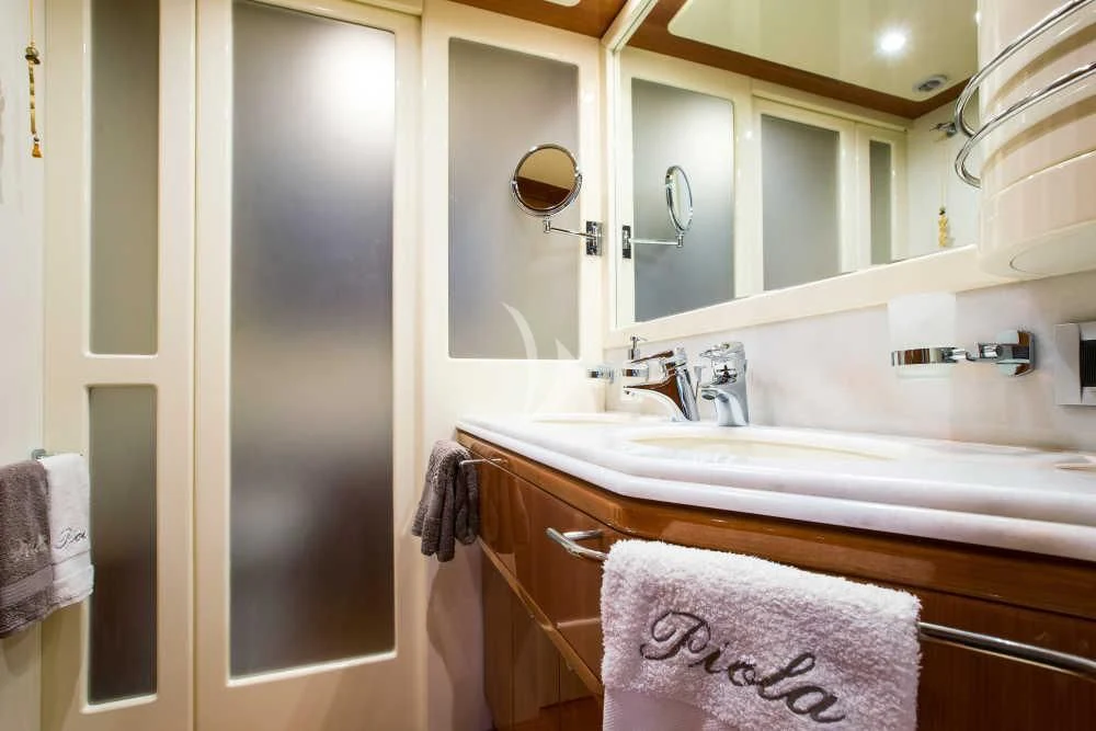 a bathroom with a sink and a mirror aboard PIOLA Yacht for Sale