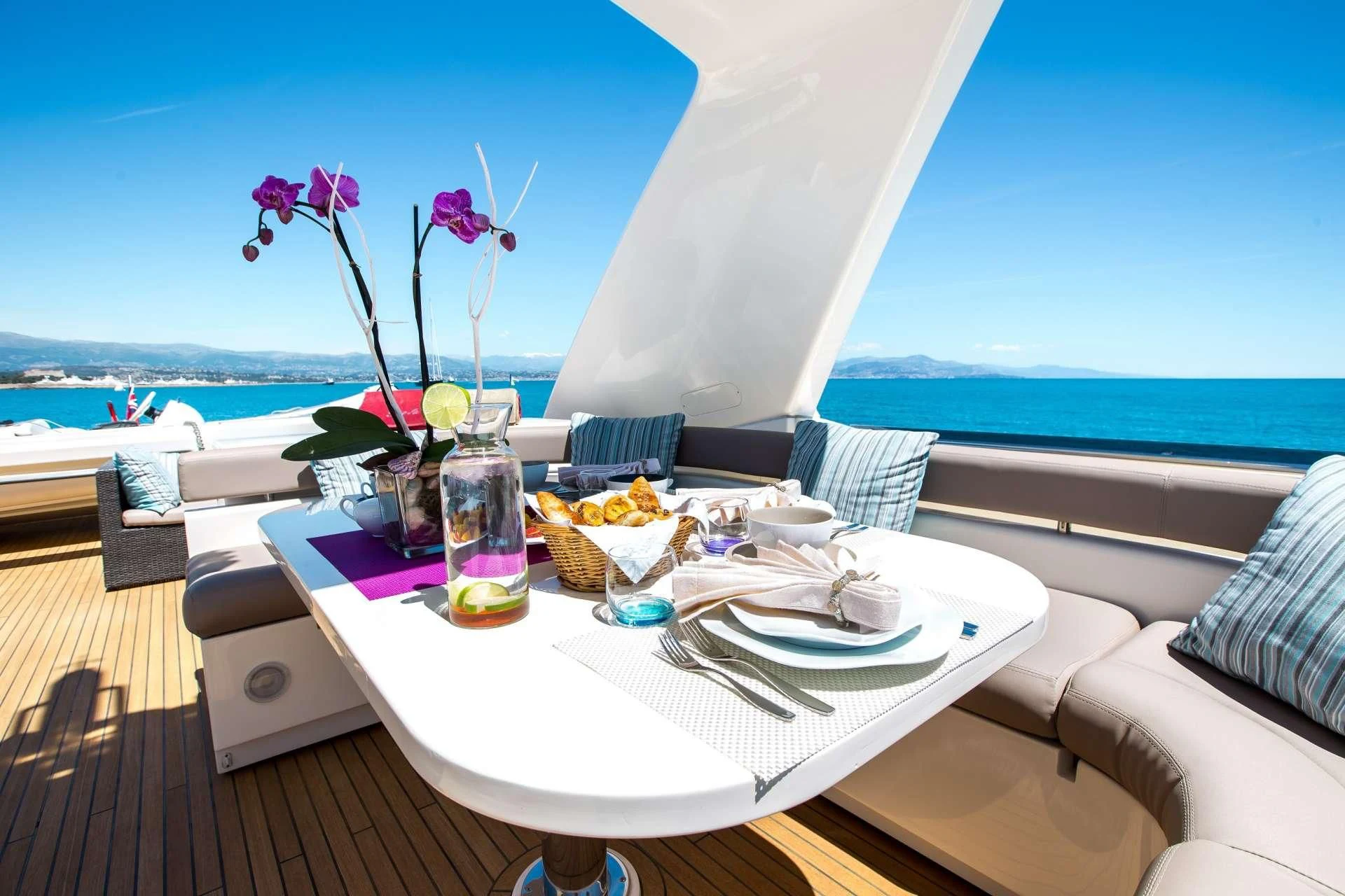 a table with food and drinks on it aboard PIOLA Yacht for Sale