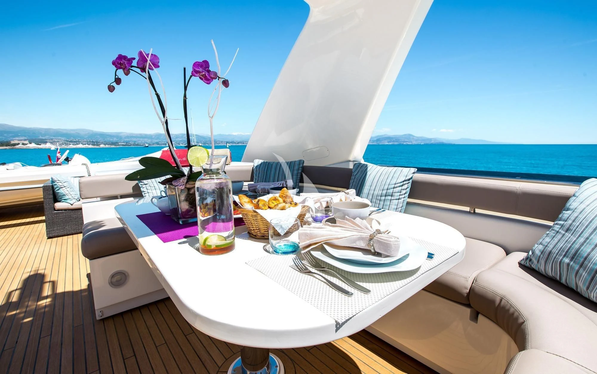 a table with food and drinks on it aboard PIOLA Yacht for Sale