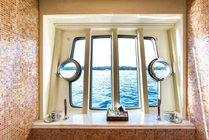 a bathroom with a large window aboard PIOLA Yacht for Sale