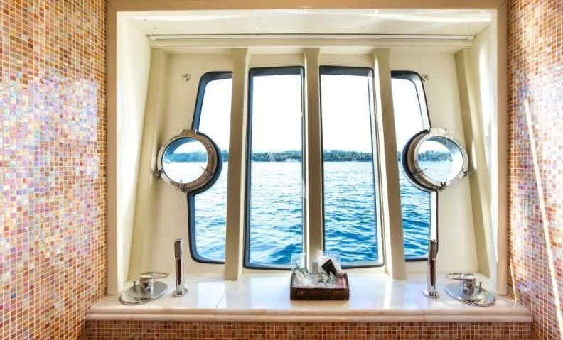 a bathroom with a large window aboard PIOLA Yacht for Sale