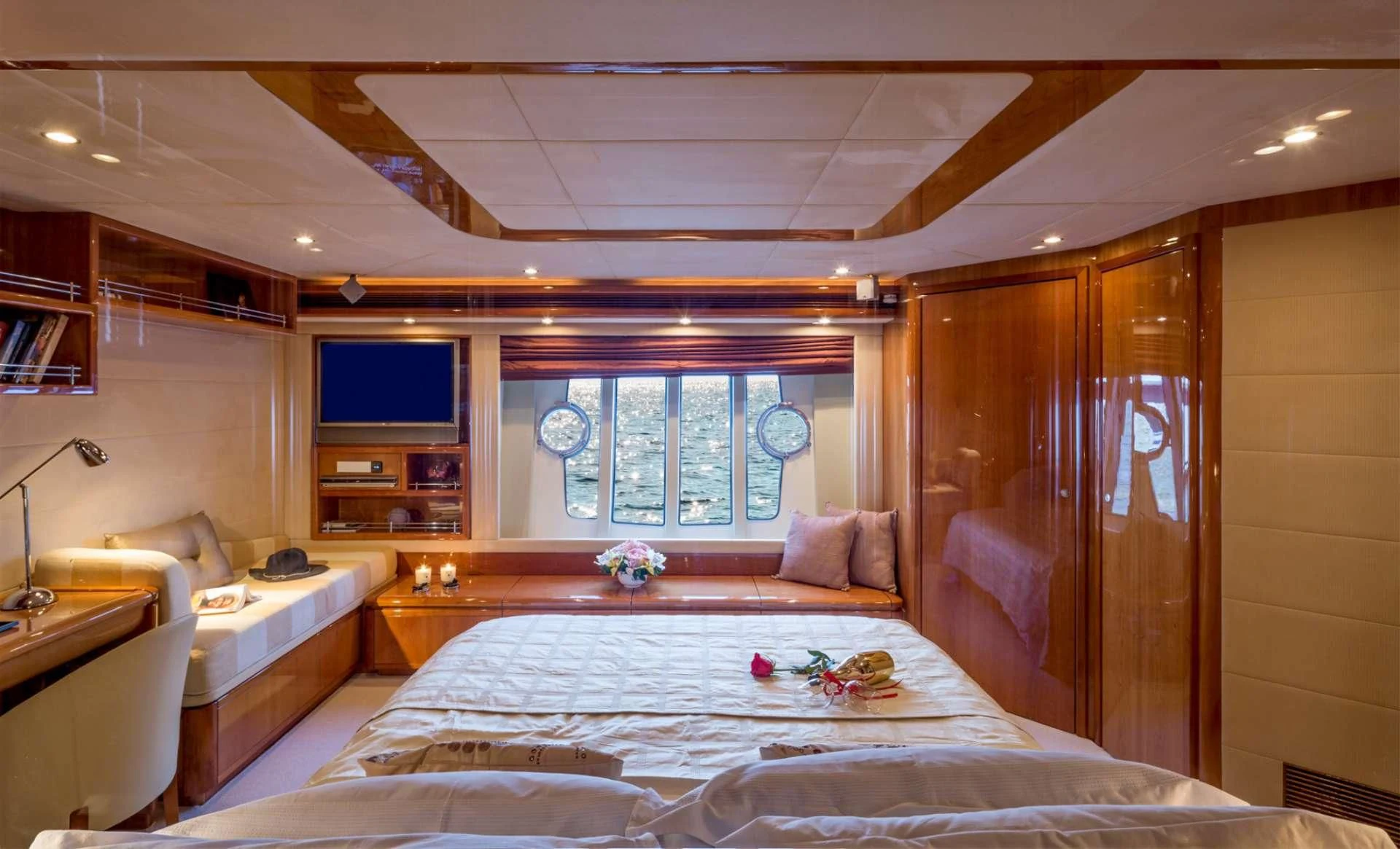 a bedroom with a large mirror aboard PIOLA Yacht for Sale