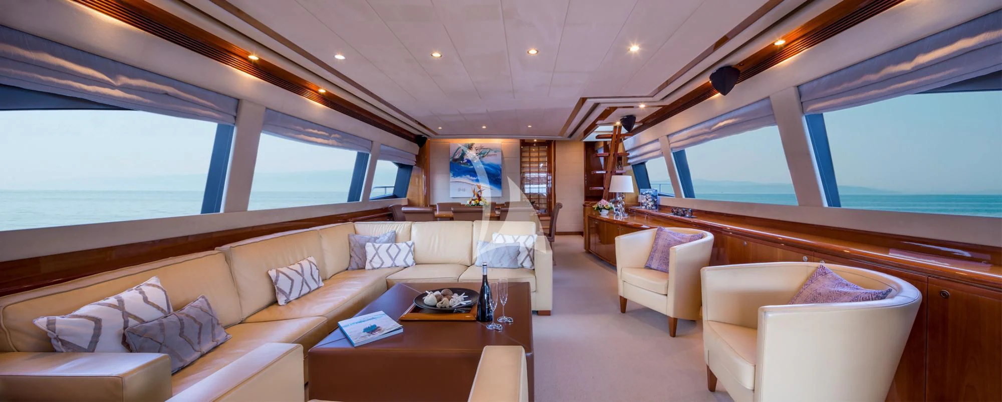 a room with a couch and a table and a window aboard PIOLA Yacht for Sale