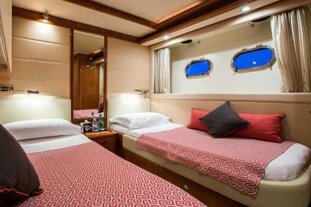 a room with two beds aboard PIOLA Yacht for Sale