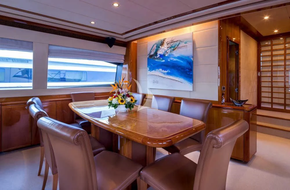 a dining table in a room aboard PIOLA Yacht for Sale