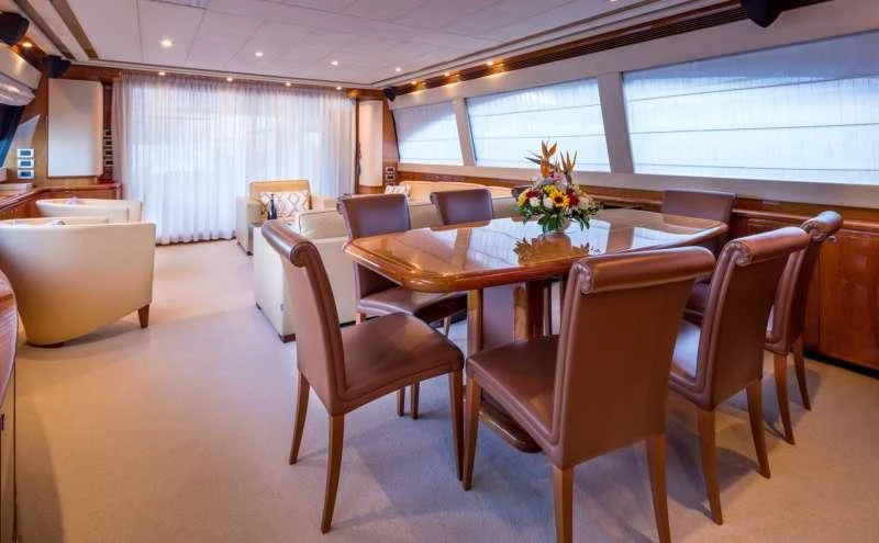 a dining room with a table and chairs aboard PIOLA Yacht for Sale