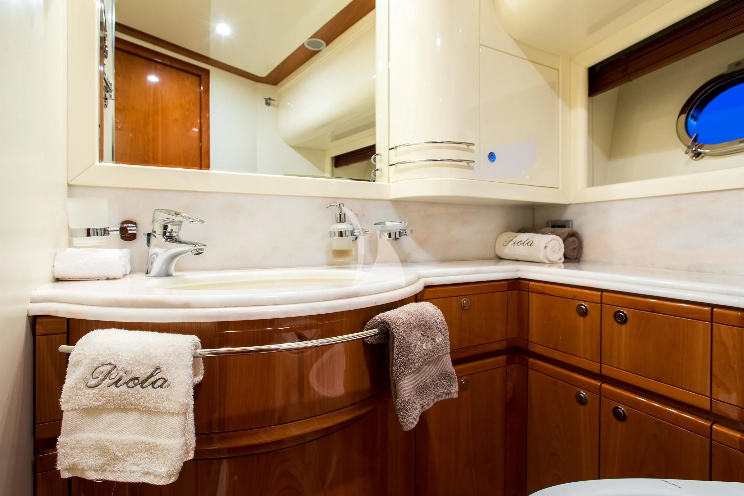 a bathroom with wooden cabinets aboard PIOLA Yacht for Sale