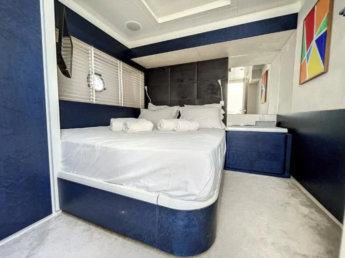 a room with a bed and a desk aboard LA FENICE Yacht for Charter
