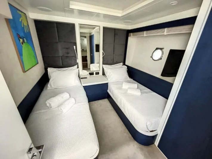 a room with beds and a window aboard LA FENICE Yacht for Charter